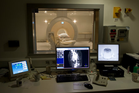 mri-scan MRI scan image and view of an MRI machine. It is a hoop shape, with a person going through the centre.